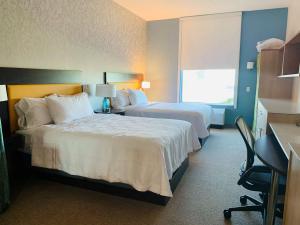a hotel room with two beds and a window at Home2 Suites By Hilton Edinburg in Edinburg