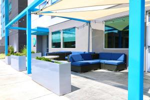 a patio with a blue couch under a canopy at TRU By Hilton Clarksville in Clarksville