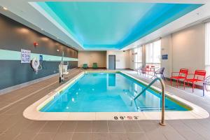 a swimming pool in a hotel room with a large ceiling at TRU By Hilton Clarksville in Clarksville