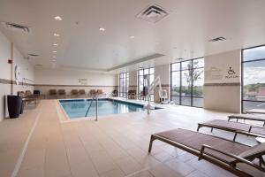 a swimming pool in a large room with chairs at Hampton Inn Morristown, I-81, TN in Morristown