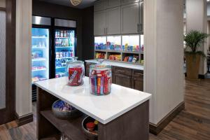 a kitchen with two jars on a counter with a refrigerator at Homewood Suites By Hilton Greensboro Wendover, Nc in Greensboro