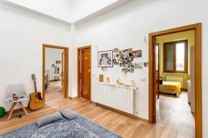 a living room with a bed and a guitar at Affittacamere Pagoda RECANATI in Recanati