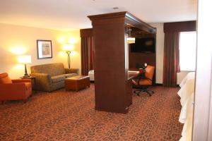 a hotel room with a bed and a desk at Hampton Inn and Suites Peru in Peru