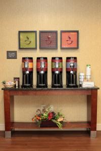 a shelf with four coffee machines on it at Hampton Inn Milan in Milan