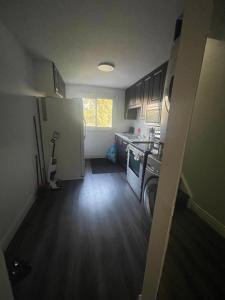 a small kitchen with a washer and dryer in it at Mo's Place in Mississauga