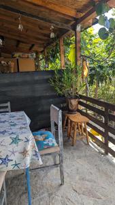 a patio with a table and chairs and a potted plant at Guest House Chalakov in Sinemorets
