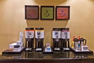 a group of coffee machines sitting on a counter at Hampton Inn Quincy in Quincy
