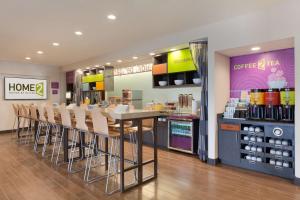 a store with a bar with chairs and a counter at Home2 Suites By Hilton Oklahoma City Quail Springs in Oklahoma City