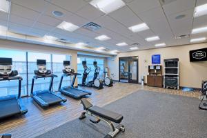 a gym with treadmills and exercise bikes in a room at Hampton Inn & Suites Lubbock University, Tx in Lubbock