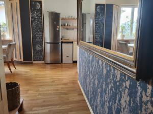 a kitchen with stainless steel refrigerators and a counter with a mirror at Sunny Panorama Flat near Castle with balcony in Budapest