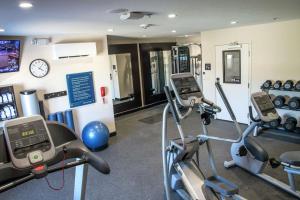 a gym with two cardio machines and a clock at Hampton Inn Hartwell Ga in Hartwell