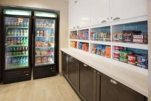 a kitchen with two refrigerators with food and drinks at Homewood Suites By Hilton Paducah in Paducah
