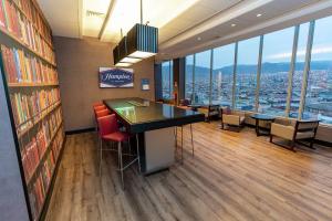 a library with a table and chairs and a view of the city at Hampton By Hilton Antofagasta in Antofagasta