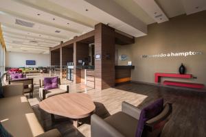a waiting room with a table and chairs at Hampton By Hilton Bucaramanga in Bucaramanga