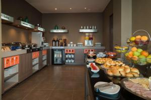 a large kitchen with many plates of food on a counter at Hampton By Hilton Bucaramanga in Bucaramanga