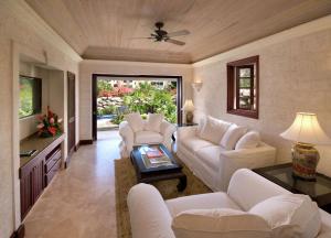 a living room with white furniture and a ceiling fan at Hilton Grand Vacations Club The Crane Barbados in Saint Philip