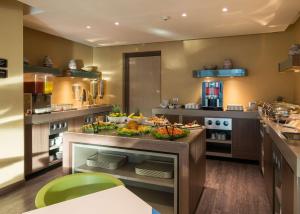 a kitchen with a counter with food on it at Hampton by Hilton Barranquilla in Barranquilla +36 photos