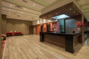 a lobby with a reception desk in a building at Hampton By Hilton Bogota Airport in Bogotá