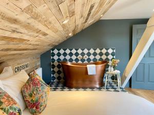 a bedroom with a large bed with a wooden ceiling at Railway House York by Chateau Anna in York