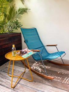 a blue chair and a table on a patio at B&B Kas ChuChubi in Kralendijk