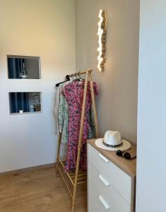 a room with a clothes rack and a dresser at AMMOS Beach apartment in Sidari