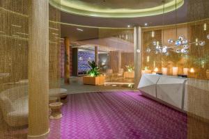 a hotel lobby with a purple carpet and a reception desk at The Fives Downtown Hotel & Residences, Curio Collection by Hilton in Playa del Carmen
