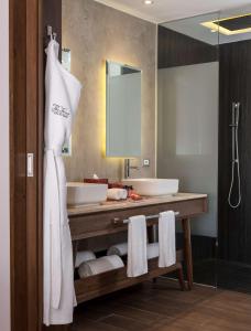 a bathroom with two sinks and a mirror at The Fives Downtown Hotel & Residences, Curio Collection by Hilton in Playa del Carmen