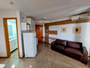 a living room with a couch and a refrigerator at Apart Hotel Life Resort - Beira Lago N D15 in Brasília