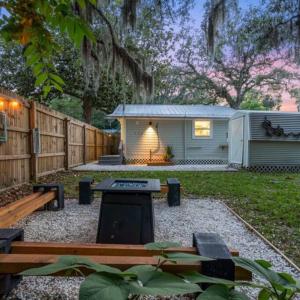 a backyard with a picnic table and a shed at Quiet get away in a vibrant city in St. Augustine