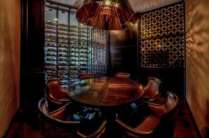 a dining room with a wooden table and chairs at Hilton Garden Inn Guatemala City in Guatemala