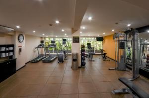 a gym with treadmills and machines in a room at Hilton Garden Inn Guatemala City in Guatemala