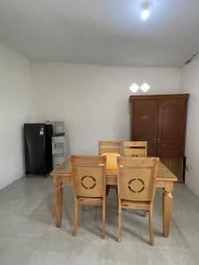 a wooden table and chairs in a room at Mawar Homestay in Banda Aceh
