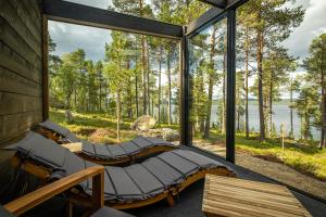 a room with two beds and a large window at Norlight Cottages Ivalo - Aurinko West in Ivalo