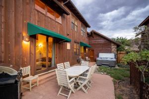 een terras met een tafel en stoelen en een barbecue bij Coyote Run #2 - Stunning Views in Moab +20 foto's