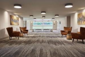 a waiting room with chairs and a projection screen at DoubleTree by Hilton Managua in Managua