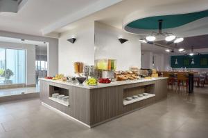 a kitchen with a counter with food on it at DoubleTree by Hilton Managua in Managua