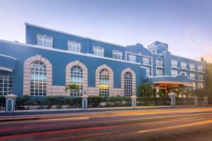 a large blue building on the side of a street at Villa Mercedes Curio Collection By Hilton in Mérida