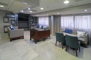 Hampton Inn Monterrey-Airport في مونتيري: غرفة انتظار مستشفى مع طاولة وكراسي