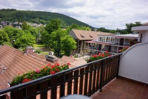 a balcony with a view of a house and flowers at Hotel Lorösch in Bad Orb