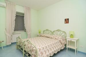 Ένα ή περισσότερα κρεβάτια σε δωμάτιο στο Casetta Roby