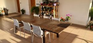 a large wooden table and chairs in a room at Casa Nostra in Imola