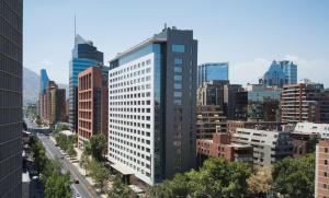 a tall building in the middle of a city at DoubleTree by Hilton Santiago - Vitacura in Santiago