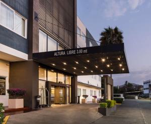 a building with a sign that reads alpha lease at DoubleTree by Hilton Queretaro in Querétaro