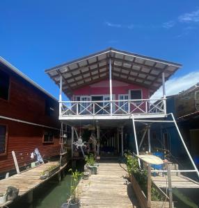 a house on the water with a dock at Life is Good in Bocas del Toro