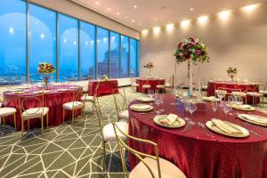 a banquet hall with tables and chairs and large windows at Gran Hotel Costa Rica, Curio Collection By Hilton in San José