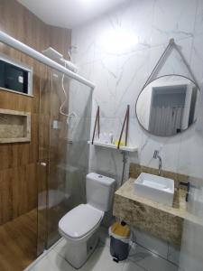a bathroom with a toilet and a shower and a sink at Condomínio Dunas Residence - Casa 7 e Casa 10 - Santo Amaro - MA in Santo Amaro
