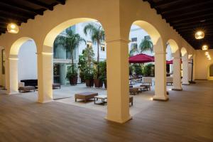 an arcade with tables and chairs in a building at Doubletree By Hilton Toluca in Toluca