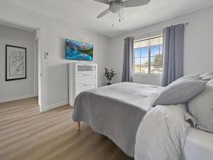 a bedroom with a bed and a tv on the wall at Discount For 30 Days Plus Stay In Culver City in Los Angeles