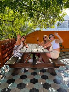 a group of women sitting at a picnic table at Hostal Hidalgo in Guadalajara