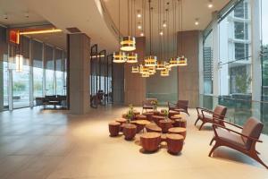 a lobby with a table and chairs and a chandelier at DoubleTree by Hilton Santiago Kennedy, Chile in Santiago